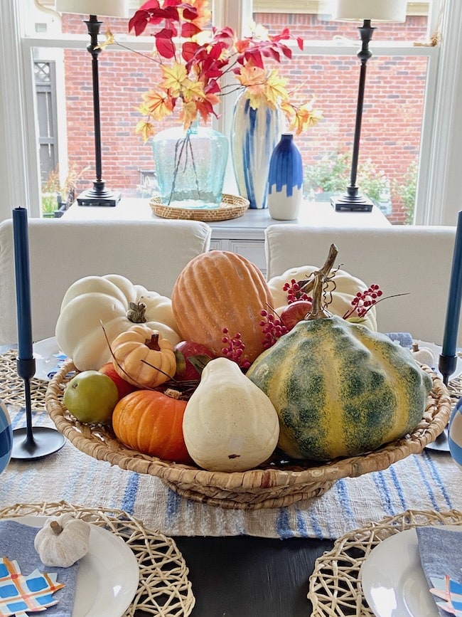 centerpiece with gourds and pumpkins with window in background