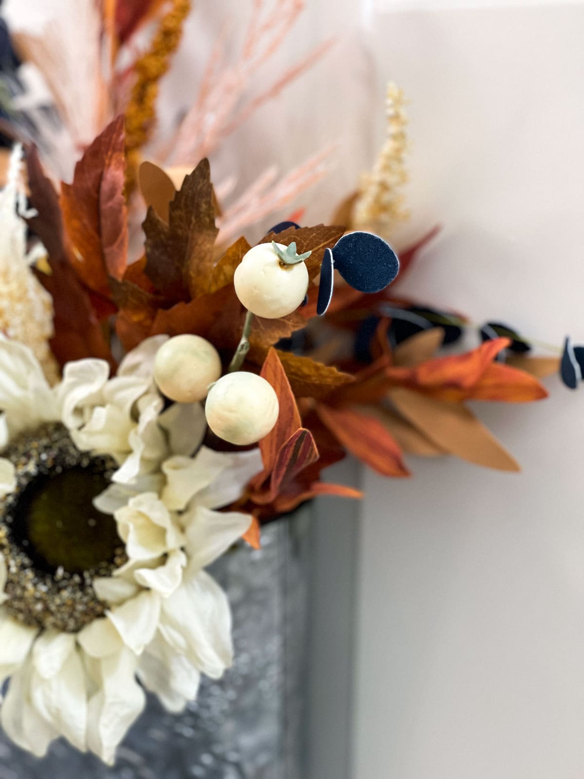 fast and easy fall tin door decor closeup of white berries against fall florals