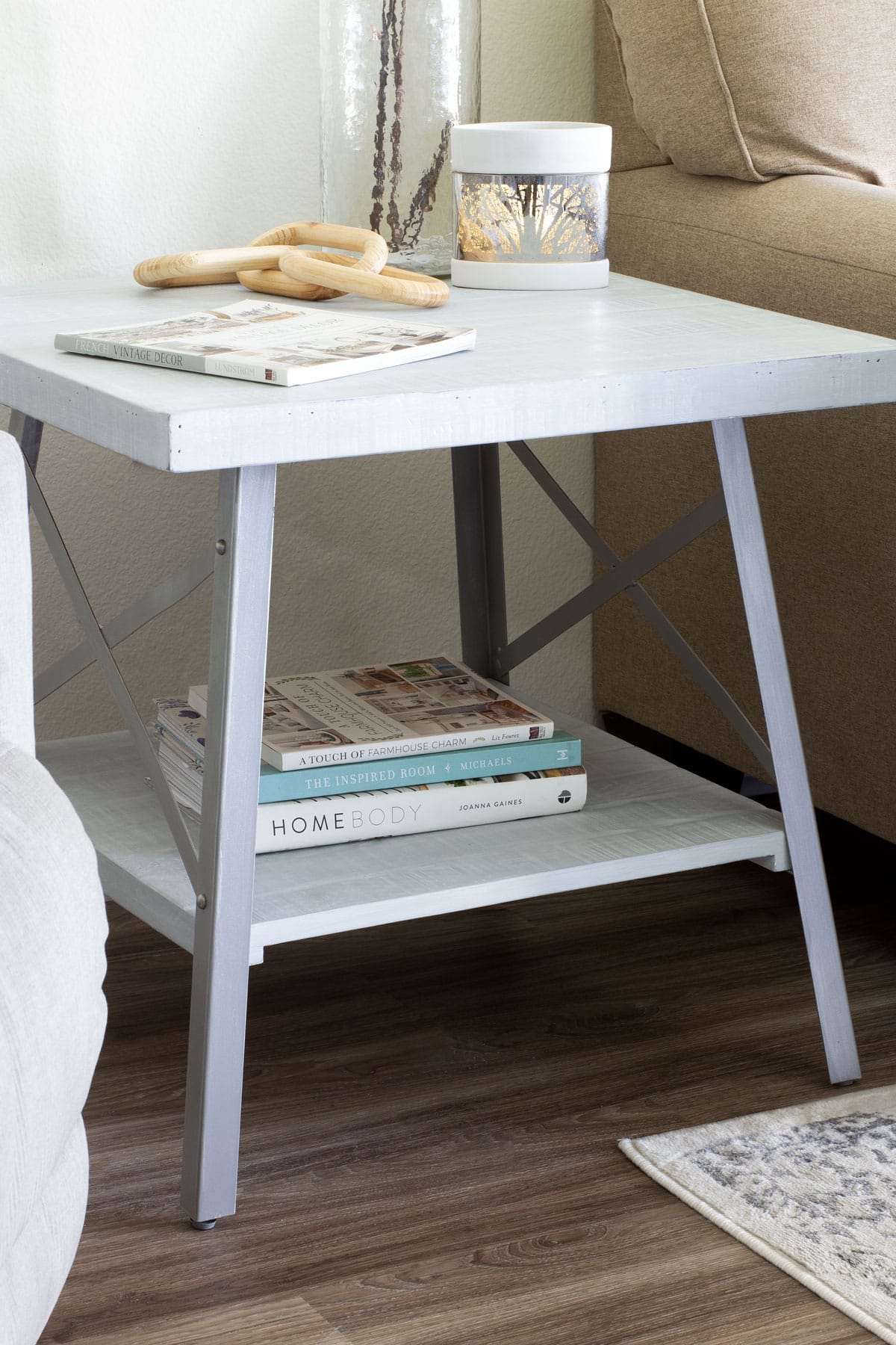 light gray sidetable with books and decor