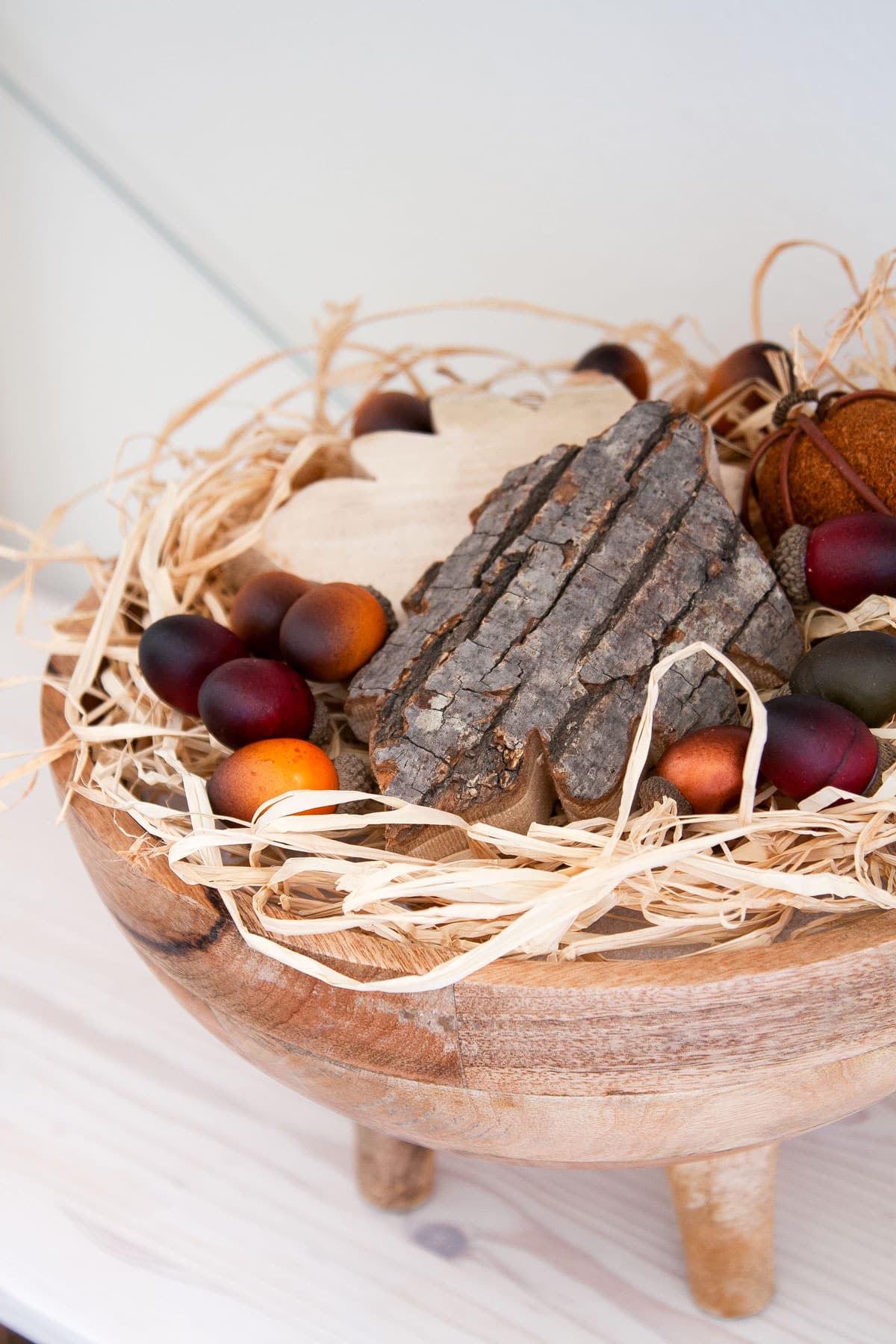 bowl of dried grass and wooden leaves with acorns
