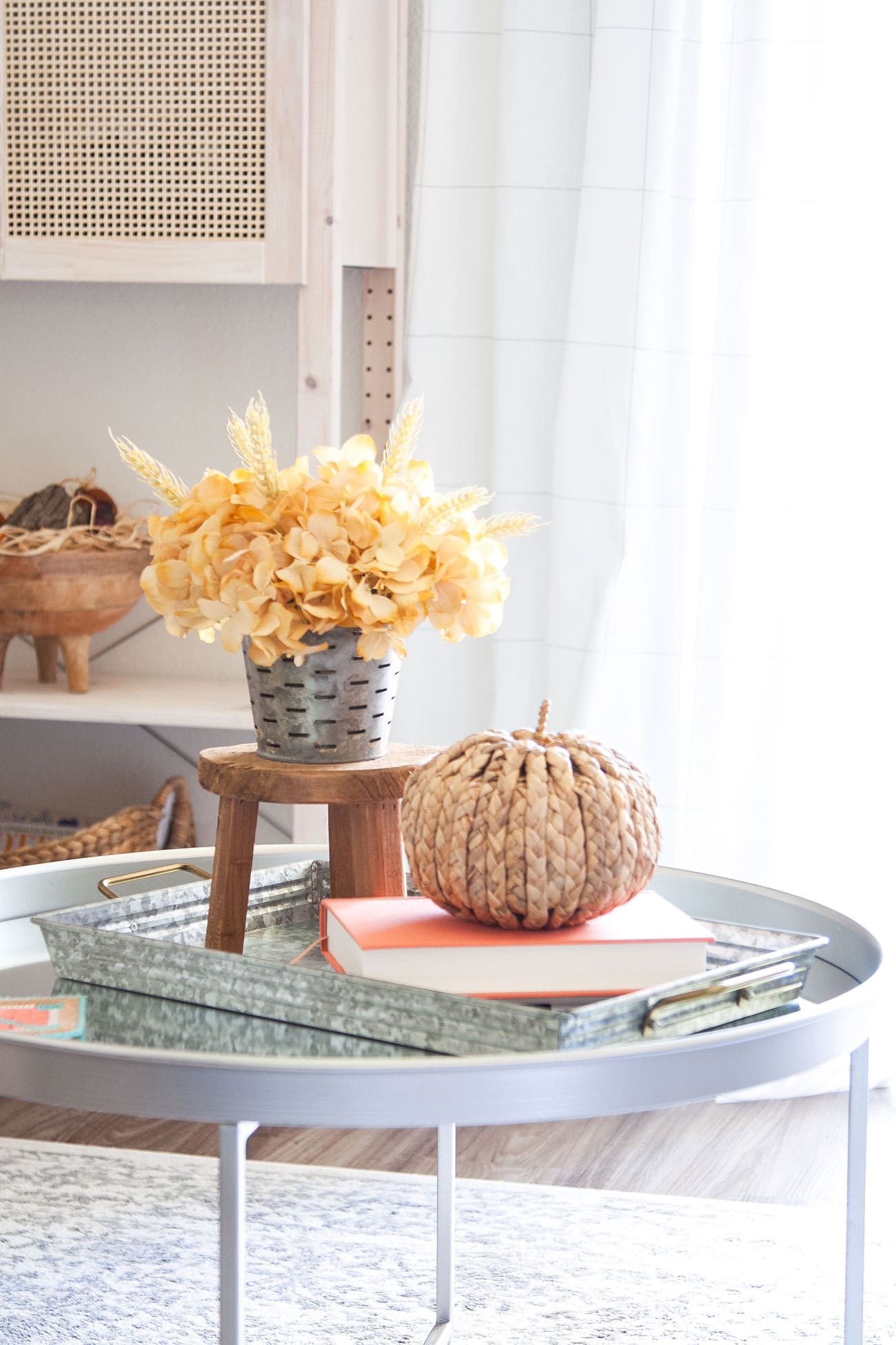 small apartment fall living room tour coffee table with fall florals and weaved pumpkin