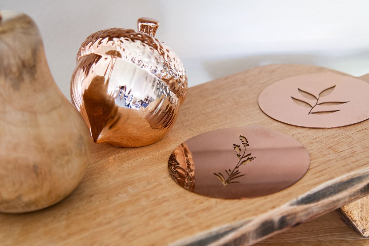 copper acorn and coffee art templates on wood surface