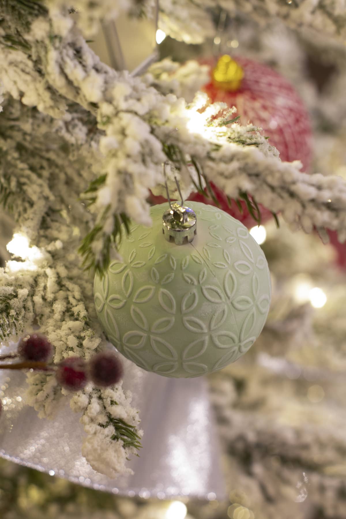 mint ornament in christmas tree with twinkle light