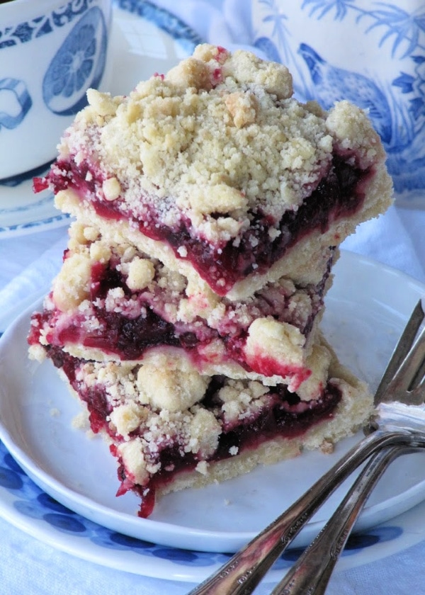 stack of cranberry bars with fort and white plate