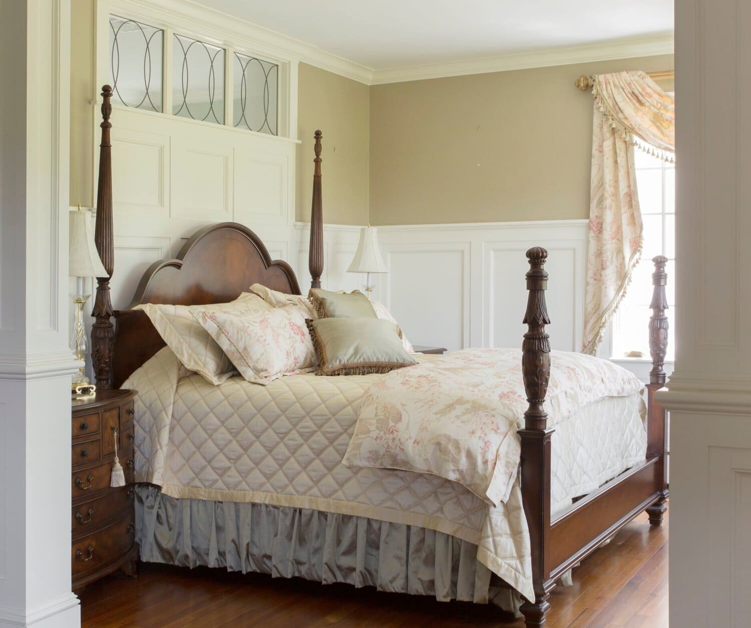 bedroom with four poster bed and neutral tones