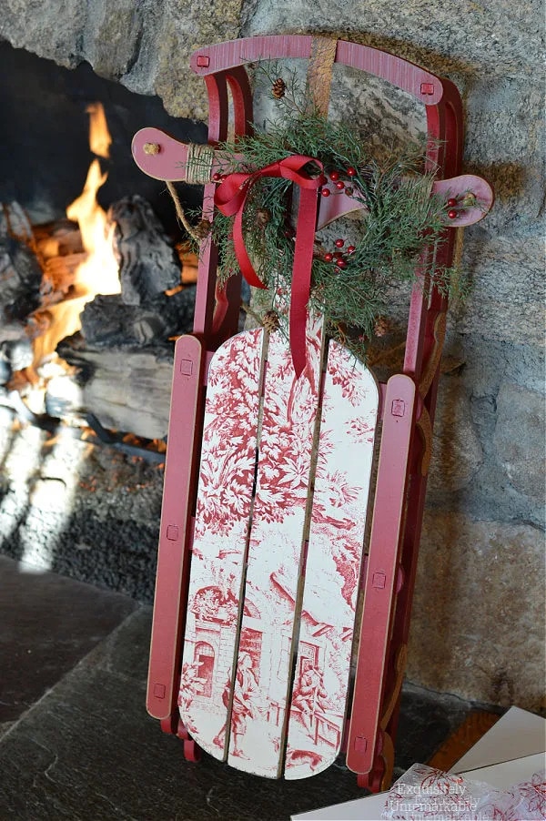 red and white sled standing against fireplace