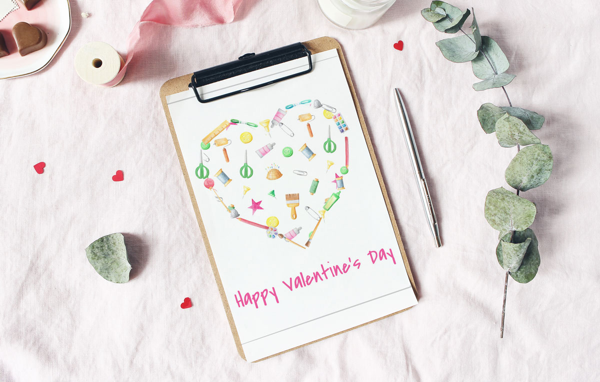 free watercolor valentine heart card on clipboard with ribbon and pen on linen covered surface