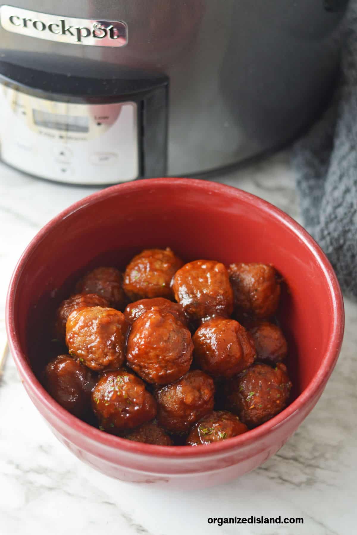 meatballs in sauce in red bowl