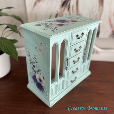 Tuesday turn about 188 fanciful diys pale green jewelry box with purple pansies on side and top sitting on wood surface