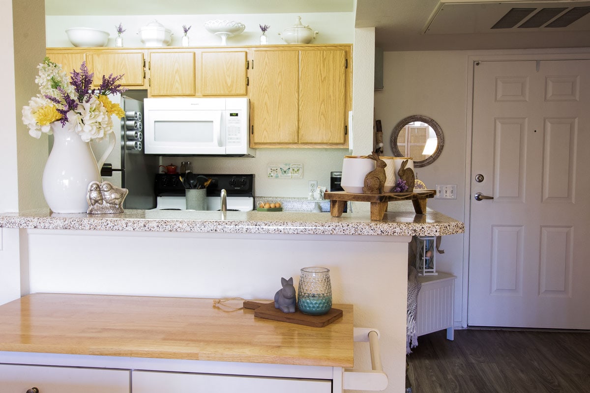 apartment kitchen with honey oak cabinets and spring decor