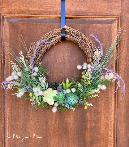 tuesday turn about 194 refreshing spring diys grapevine wreath with spring flowers and succulents on wood door