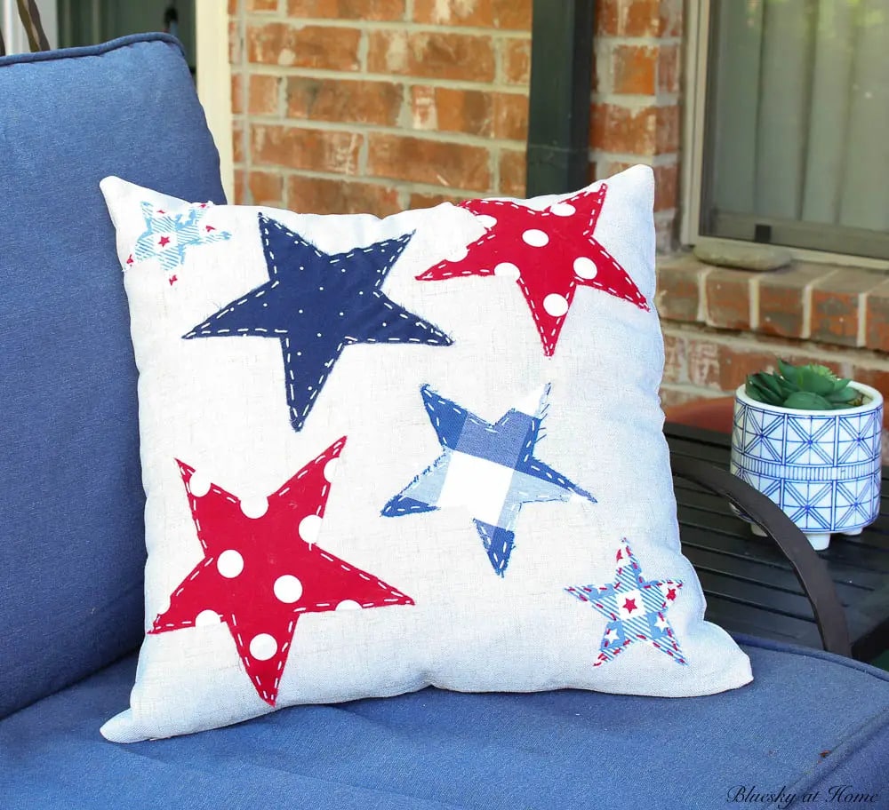 patriotic pillow with red white and blue stars on patio chair