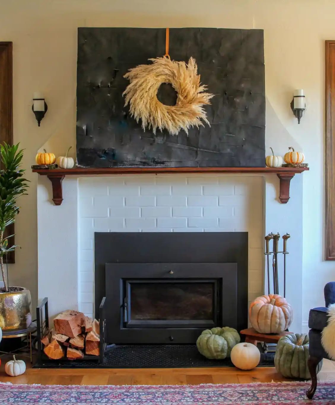 fireplace with mantel and fall decor including pampas grass wreath