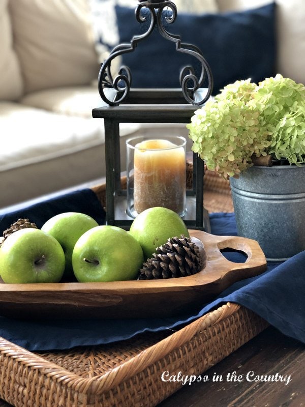 tabletop fall decor with apples hydrangeas and candles