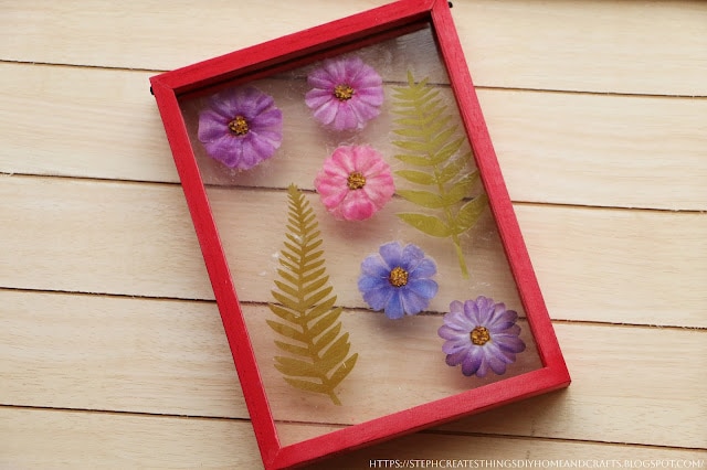 tuesday turn about 215 falling for diys pressed flower art in frame on wooden board surface