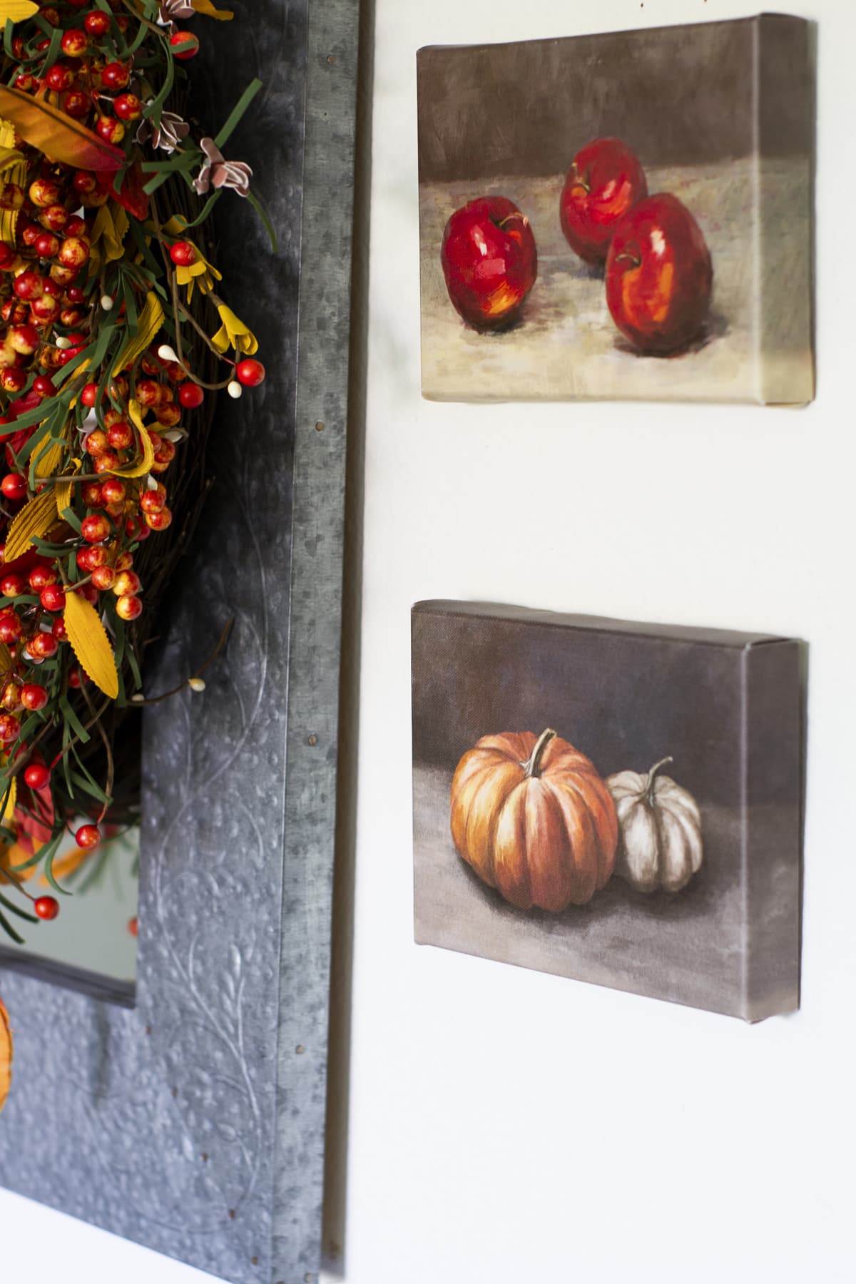 paintings of pumpkins and apples on wall