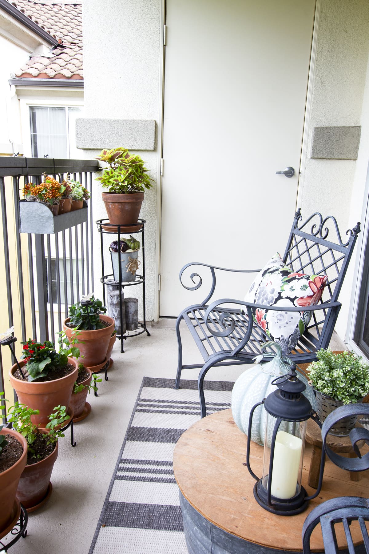 how to decorate your cozy apartment with fall faux florals balcony with fall plants and furniture