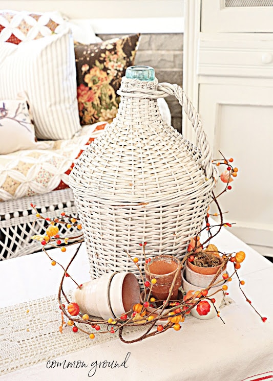 woven demijohn with fall elements on table