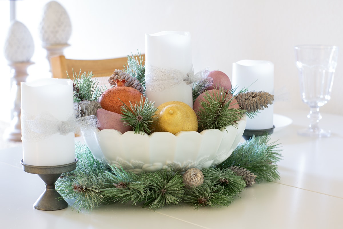 pastel christmas centerpiece with faux sugared fruits dining table with centerpiece and candles in dining room