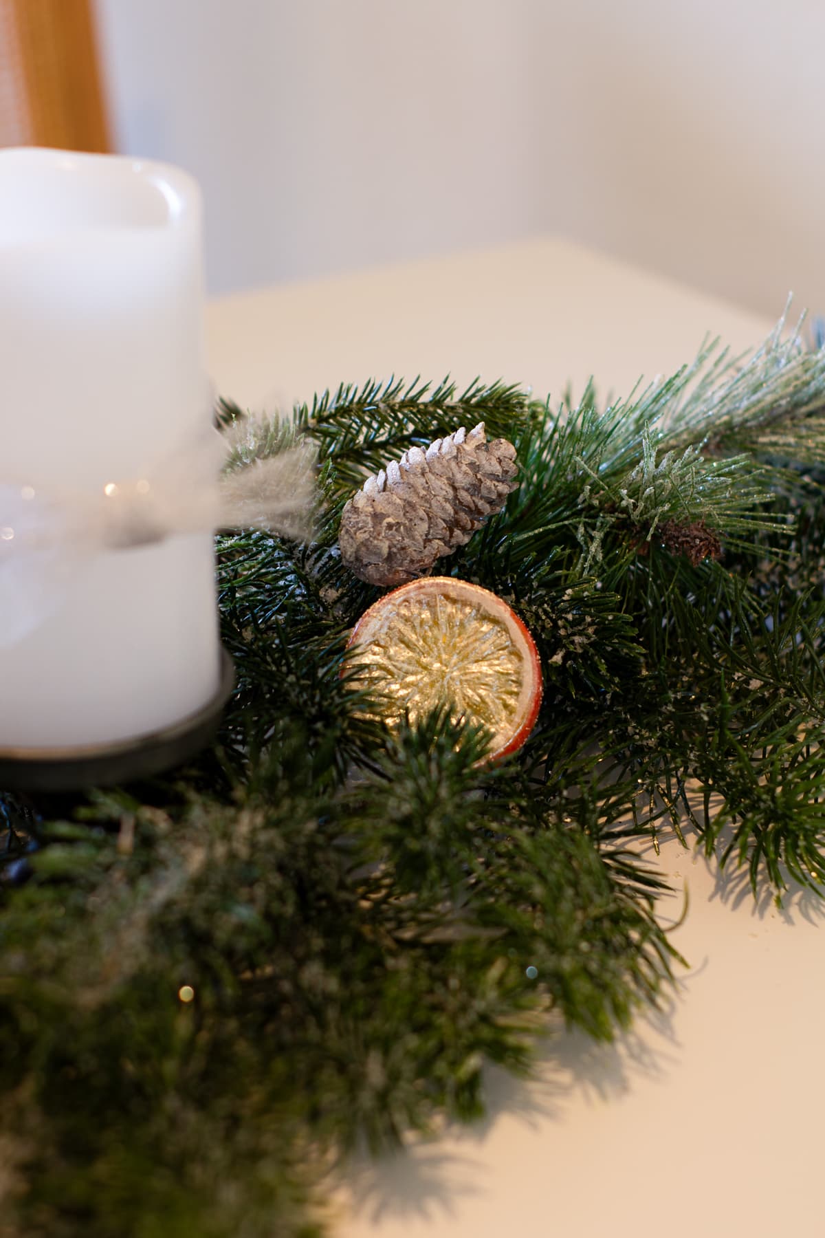 no mess faux sugar coated fruits orange slice in pine sprigs with pine cones and white candle