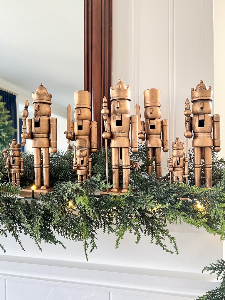 tuesday turn about 232 Christmas bakers dozen nutcrackers on mantel with greenery