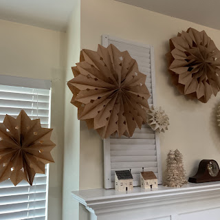 paper bag snowflakes and stars above mantel