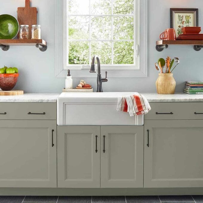 green and white kitchen with decor and utensil items displayed kitchen table in corner