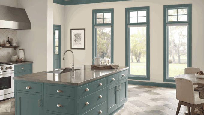 dark sage green cabinets with white backsplash and gray accents